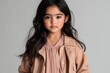 © Oleh Marchak - Young girl wearing a pastel dress stands against a light background with a thoughtful expression during a studio photoshoot in the afternoon
