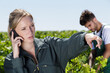© auremar - female vintner talking on mobile phone in vineyard
