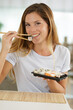© auremar - a woman eating sushi food