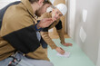 © auremar - tiler and co-worker at indoor floor tiling renovation