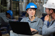 © auremar - industrial factory workers with laptop and hardhat on