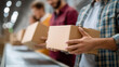 © Denis Yevtekhov - Close-up of warehouse workers handling packages in distribution center, logistics operations focus, shipping process efficiency, parcel sorting workflow, supply chain management, d