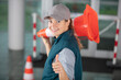 © auremar - happy female builder holding traffic cone