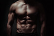 © AI_images - athletic male torso with strong abs under soft studio lighting, clean dark background, commercial fitness aesthetic.