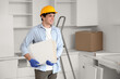 © Pixel-Shot - Male worker with shelves assembling furniture in kitchen