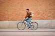 © Oscar - Man riding bicycle delivering package in city street
