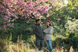 © chokniti - Couple in love enjoying nature travel, romantic relationship with happiness togetherness, smiling partners under blooming cherry blossoms, peaceful outdoor lifestyle