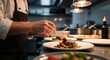 © DAVA - A chef meticulously plates a prepared dish with a small spoon in a professional kitchen