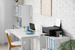 © Pixel-Shot - Shelving unit with modern printer and folders in light home office