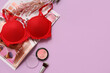 © Pixel-Shot - Composition with red bra, magazine and cosmetics on lilac background