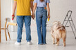 © Pixel-Shot - Young couple with cute dog and rollers planning painting walls in their new home