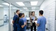 © Alfin - Medical team gathered around a female leader in a modern hospital office discussing treatment plans
