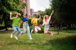 © deagreez - Group of cheerful friends enjoying their leisure time outdoors on a sunny day in the city park