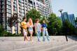 © deagreez - Group of young diverse friends enjoying time together outdoors in a modern urban area