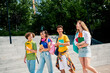 © deagreez - Group of diverse students walking together outdoors on campus stairs carrying colorful notebooks and backpacks