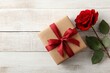 © Julia - A refined present box with a red bow and one red rose set against a wooden backdrop