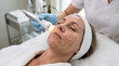 © Cliff - Close-up of a woman receiving a facial skin rejuvenation treatment with a modern cosmetic device in a beauty clinic, professional aesthetic procedure and skincare