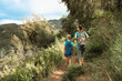 © kieferpix - Mother and son hiking mountain trail together with backpacks exploring nature