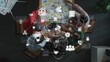 © InfiniteFlow - A diverse group of professionals engages in a collaborative business meeting. The table is covered with data charts, while digital icons symbolize technology and communication. Raster