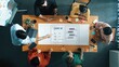© InfiniteFlow - A diverse team collaborates on developing a user interface for an AI chat application. They gather around a wooden table with laptops, notes, and coffee, fostering creativity. Raster