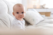 © New Africa - Portrait of cute little baby on sofa at home. Space for text
