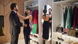 © stockbusters - Elegant couple watching mirror preparing anniversary celebration wardrobe room