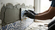© ArionArt - a man installing wall tiles