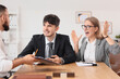 © Pixel-Shot - Male business mediator working with angry clients at table in office
