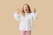 © Pixel-Shot - Portrait of cheerful little girl on beige background