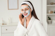 © Pixel-Shot - Beautiful young happy woman with clay mask in spa salon