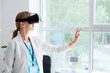 © Pixel-Shot - Female doctor using VR glasses at hospital