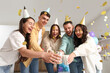 © Pixel-Shot - Group of young friends with drinks celebrating Birthday at party in kitchen