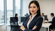 © ChimE - Confident Leader in Modern Office: A poised businesswoman stands with arms crossed, exuding confidence against the backdrop of a modern office environment.