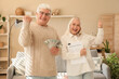 © Pixel-Shot - Happy senior couple with refund form at home
