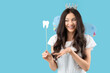 © Pixel-Shot - Young woman in fairy costume with paper tooth on blue background