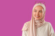 © Pixel-Shot - Young Muslim woman on purple background
