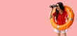 © Pixel-Shot - Female beach rescuer with lifebuoy and binoculars on pink background with space for text