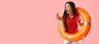 © Pixel-Shot - Worried female beach rescuer with lifebuoy and whistle on pink background with space for text