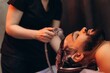 © Roman - Man receiving hair wash at professional salon