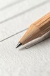 © Tetiana - Wooden pencil tip poised above textured paper, ready to make a mark, symbolizing independent work and creative process.