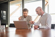 © Westend61 - Business colleagues discussing project on laptop during meeting
