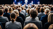 © Rahman - Large audience seen from behind during business conference or seminar with focus on curly hair attendee