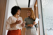 © BusinessClass by W61 - Colleagues walking and talking in a modern office hallway