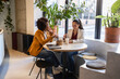 © BusinessClass by W61 - Coworkers having coffee break and discussion at workplace cafe