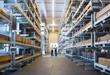 © Westend61 - Two men standing in factory warehouse