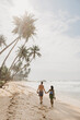 © Westend61 - Full length of couple walking on beach against sky during sunny day, Sri Lanka
