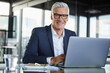 © Westend61 - Businessman working in office, using laptop
