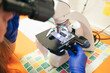 © Gonzalo Infiesta - Veterinarian checking animal sample using microscope in clinic