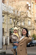 © phpetrunina14 - Mother holding toddler on city street in spring Portrait