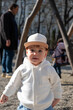 © phpetrunina14 - Toddler in white hoodie at playground on sunny day Portrait